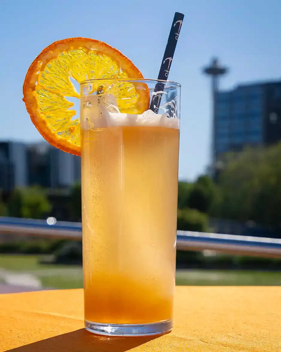 A Tipsy Tiger cocktail on a sunny day with the Space Needle in the background