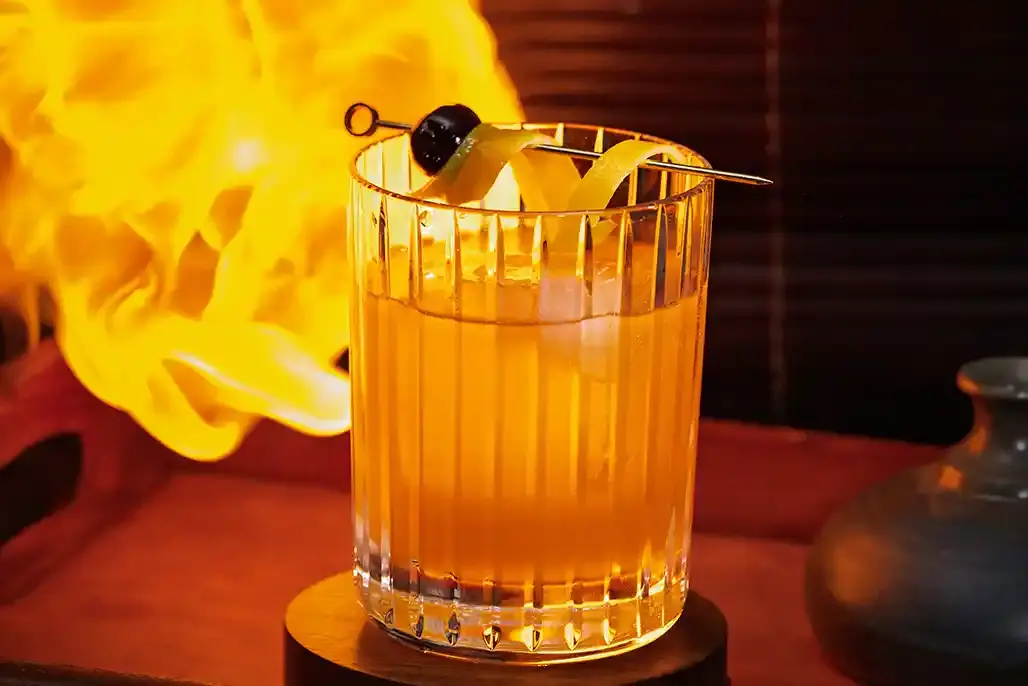 A picture of a Tipsy Tiger signature cocktail, the Snake Oil